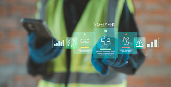 Zero accident and safety first concept industrial worker using smartphone with holographic hazard prevention and occupational health mobile app