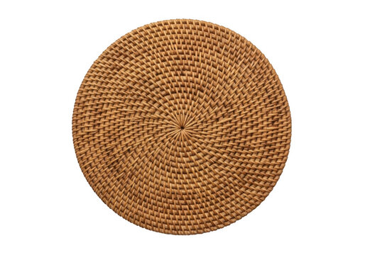 Round woven rattan placemat with a spiral pattern, isolated on a solid black background, top-down view of natural fiber kitchen accessory