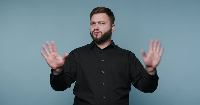 Man using sign language to communicate in a studio setting during the daytime