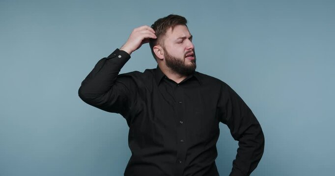 Man shows different expressions of confusion and thought while thinking about a certain topic in a studio setting
