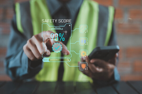 High safety score and zero accident concept industrial worker pointing at holographic compliance checkmark badge and protection shield icons
