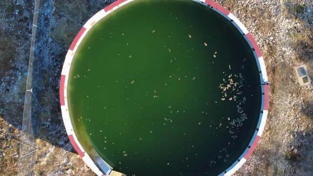 Aerial view of a circular firefighting water reservoir