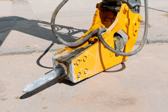 Heavy duty hydraulic breaker machine attachment for excavator performing road demolition and breaking asphalt pavement