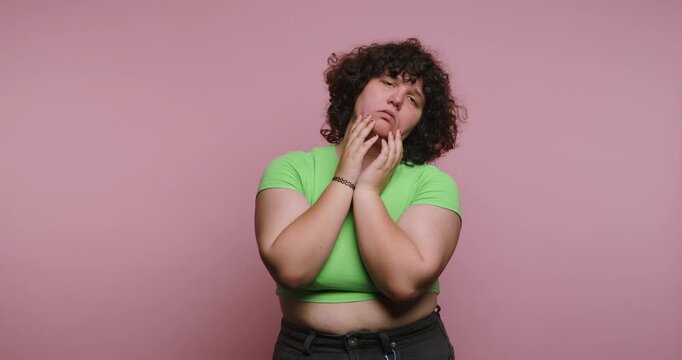 Expressions of emotions shown by a person in four frames with a pink background and simple clothing