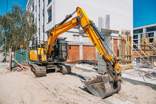 3 May 2026, Pancevo, Serbia: Yellow JCB heavy equipment excavator parked on a sandy construction site preparing ground for new building foundation
