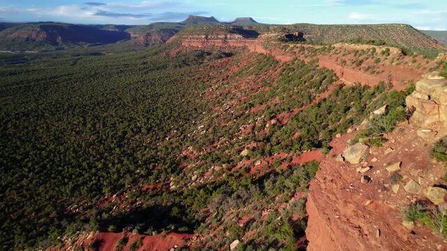 Tilt up revealing drone aerial of cliffs and Bears Ears buttes in Bears Ears National Monument, Utah.