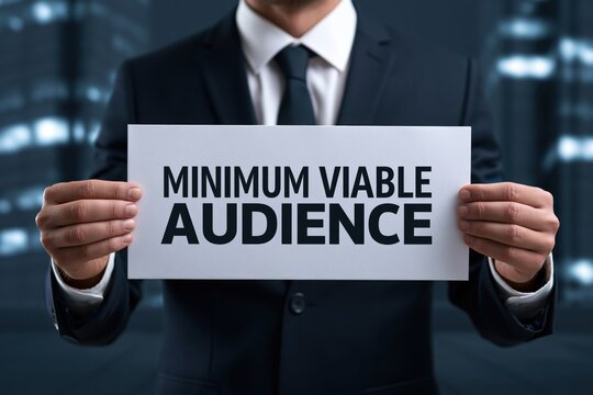 Corporate businessman holding a paper sign with minimum viable audience concept