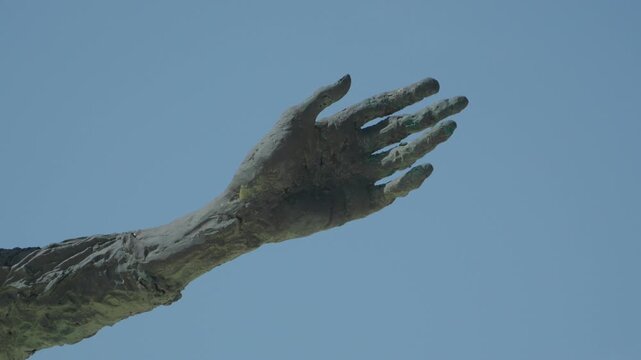 Closeup of Bronze Hand Detail on Monument to the Mother of Immigrants Statue in Gijon Spain