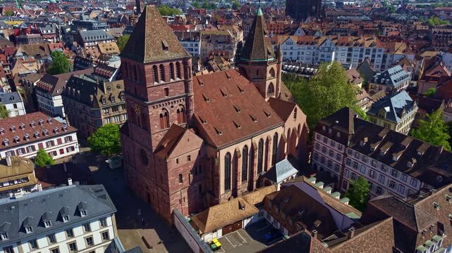 Drone panning shot of the historical and gothic protestant St Thomas' Church in Strasbourg's historic quarter, Petite France, France