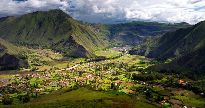 High drone view over lush Huayllabamba town in Peru's Sacred Valley of Urubamba