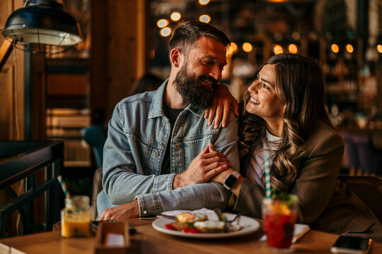 Happy couple enjoying romantic dinner date in a restaurant