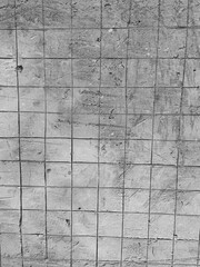 Fototapeta premium Concrete wall surface reveals grid marks and construction texture after finishing work. Concept of strength, structure, durability, and industrial development.