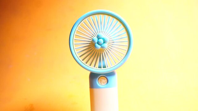 Compact handheld USB rechargeable mini fan providing portable cooling, quiet airflow, and convenient summer travel comfort.