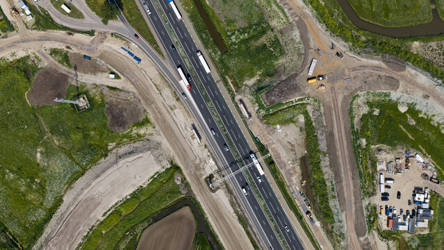 Aerial drone view of a new viaduct over the A27, showing bridge demolition, road widening, infrastructure expansion and improved access to bedrijventerrein Groote Haar.