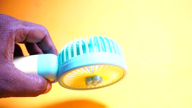 Compact handheld USB rechargeable mini fan providing portable cooling, quiet airflow, and convenient summer travel comfort.