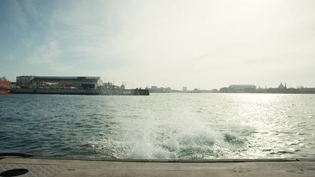 Swimming friends jump from dock for cold plunge in urban open water