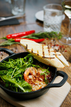 Traditional spanish tapas prawns with rocket and toasted bread