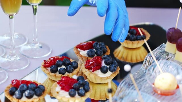 Preparing desserts with fresh fruits for a summer gathering