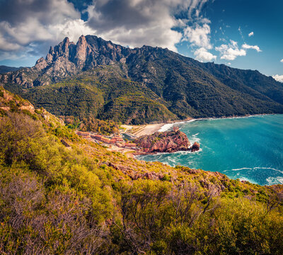 Majestic summer cityscape of Porto town with Genoise de Porto Ota castle. Picturesque morning view of Corsica island, France, Europe. Spectacular Mediterranean seascape. 