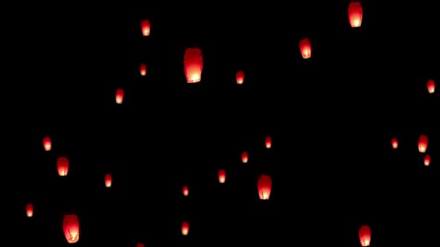 Red Sky Lanterns Floating in Dark Night Sky During Festival