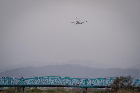 Airplane landing and take off at the airport in the city where we can see Japan alps background Toyama Japan 