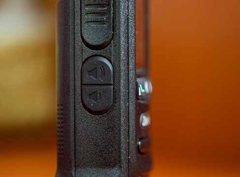 a Volume up and volume down buttons of a walkie talkie mobile wireless radio communication. Isolated by blurred background. Technology concept.