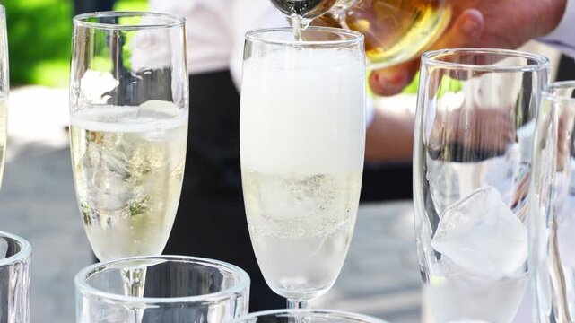 Pouring drinks for a summer gathering in the garden