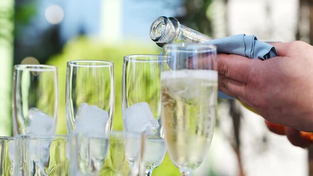 Pouring drinks for a gathering in a garden setting