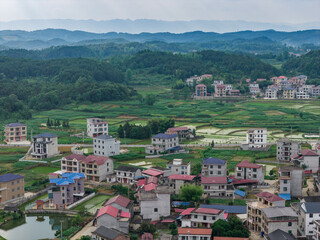 Fototapeta premium Aerial view of rural houses and green pastoral scenery