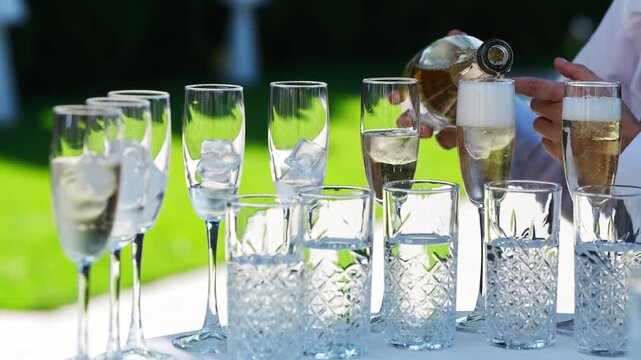 Pouring drinks at a garden party during the afternoon