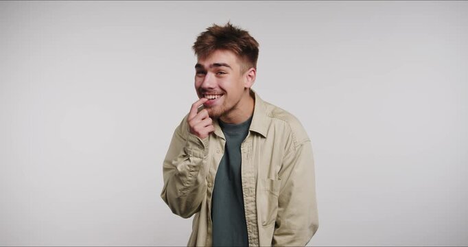 Man shows different facial expressions in studio setting during daytime activity