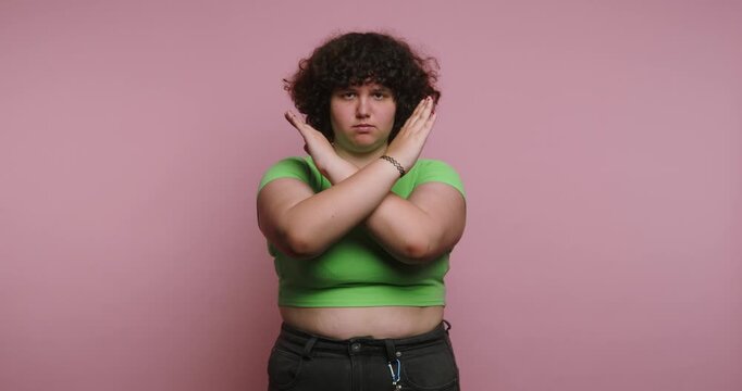 Expressing emotions through body language in four frames featuring a person with curly hair, posing against a pink background