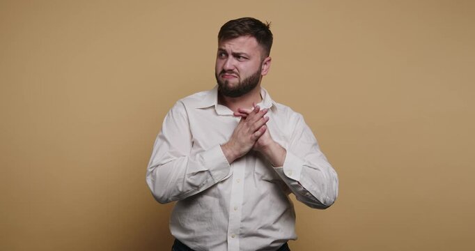 Man expresses different emotions in front of a plain background during a photo session in a studio setting