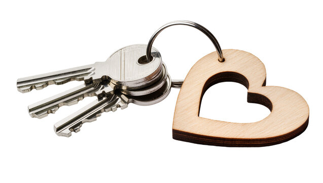 Metal keys with wooden heart keychain on white