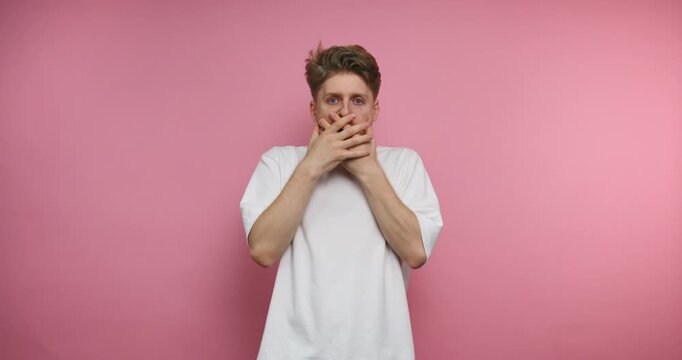 Man shows various expressions of surprise and shock in front of a pink wall at 12 PM in a bright room