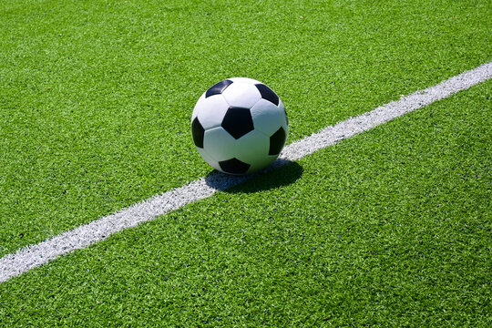 The football on the green soccer field