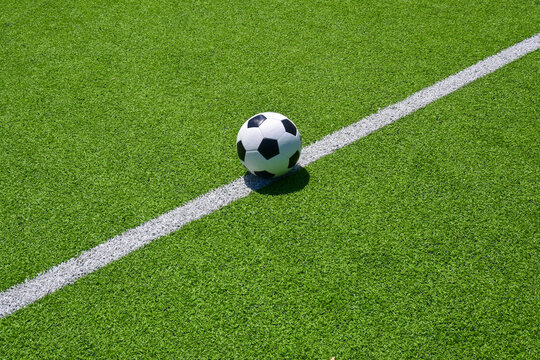 The football on the green soccer field