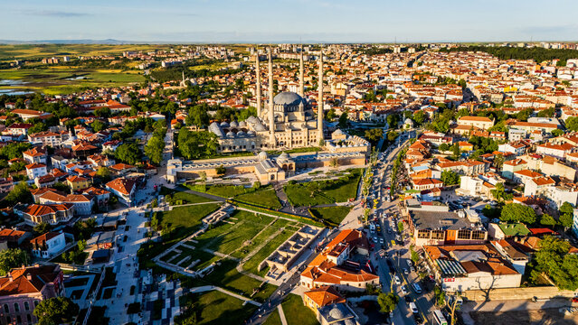 Selimiye Mosque in Edirne at sunset, showcasing Mimar Sinan imperial architecture with four high minarets, stone domes and the sprawling city background, Turkey