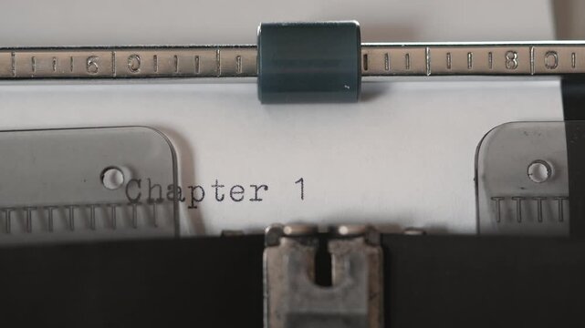 Typing the first chapter on a vintage typewriter in a quiet room during the day