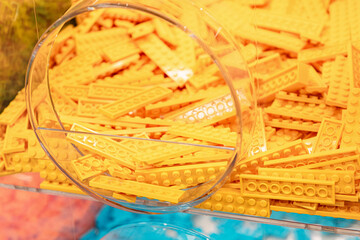 Obraz premium 19 October 2025, Belgrade, Serbia: Yellow LEGO plastic toy bricks filling a clear display bin at a retail store, offering elements for building and construction hobby