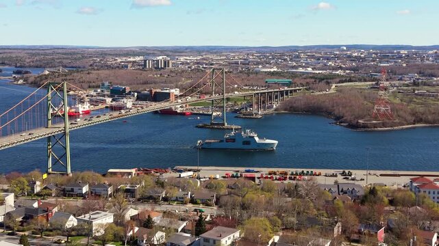 Experience the stunning sight of a modern warship navigating Halifax Bay, Nova Scotia, as it represents strength and maritime defense on the open sea