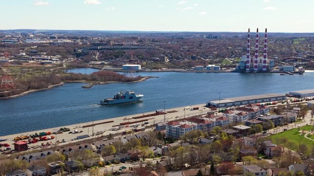 Experience a stunning aerial view of a formidable warship as it sails through Halifax Bay, showcasing Canada's naval capabilities and the breathtaking coastal scenery