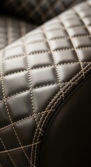 Naklejka premium Detailed Close-up of Diamond-Patterned Leather Upholstery with Stitching.
