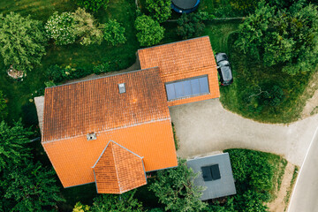 Close aerial view of single farmhouse with red tile roof and courtyard © YARphotographer