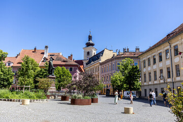 Obraz premium Historic European Town Square with Cobblestone Pavement and Clock Tower