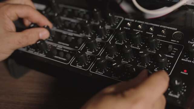 ands Tweaking Parameters on a desktop Synthesizer 