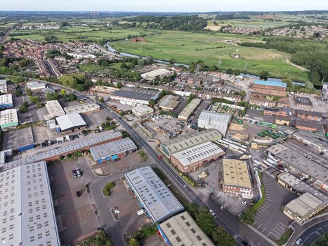 Aerial drone 4K view of town rooftops with surrounding nature Burton on Trent