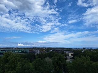 Obraz premium Tallinn, Estonia. Bright sky over city with clouds and greenery seen from a high viewpoint during daytime in an urban area