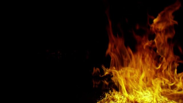 Bright orange flames dancing against a pitch black background.