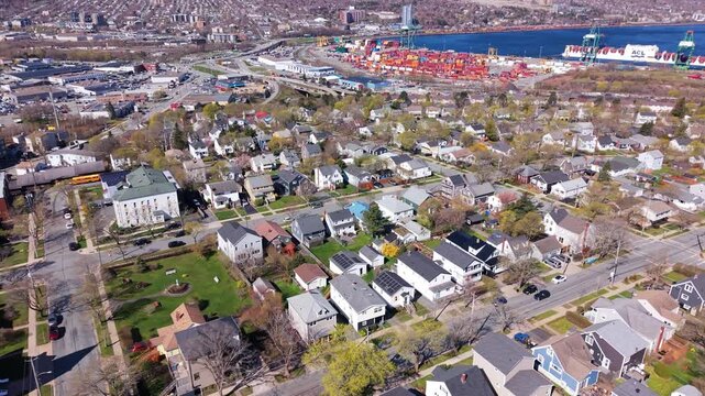 Discover the vibrant city of Halifax, Canada, showcasing its picturesque single-story homes nestled near downtown on a bright early spring day